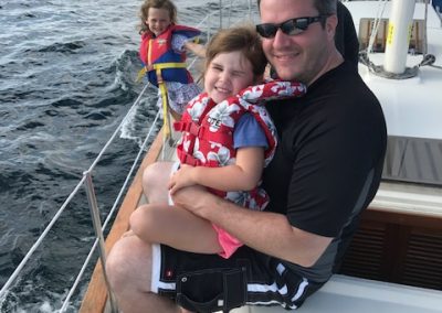 girl with dad on sailboat