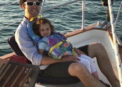 girl with dad on sailboat