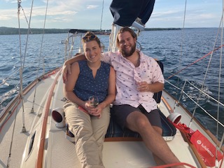 Couple on 2nd Wind sailboat on grand traverse bay in Traverse City, Michigan with WIND Sailing.