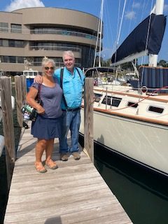 Couple about to board 2nd Wind sailboat on grand traverse bay in Traverse City, Michigan with WIND Sailing.