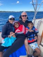 Family on 2nd Wind sailboat on grand traverse bay in Traverse City, Michigan with WIND Sailing.